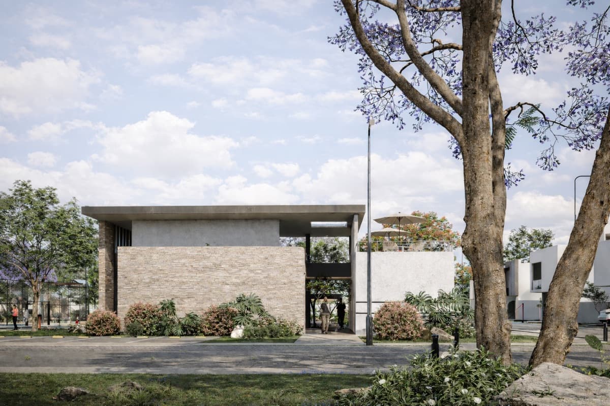 Fachada exterior de la casa club con terraza, sombrillas y jacaranda en VERA Residencial